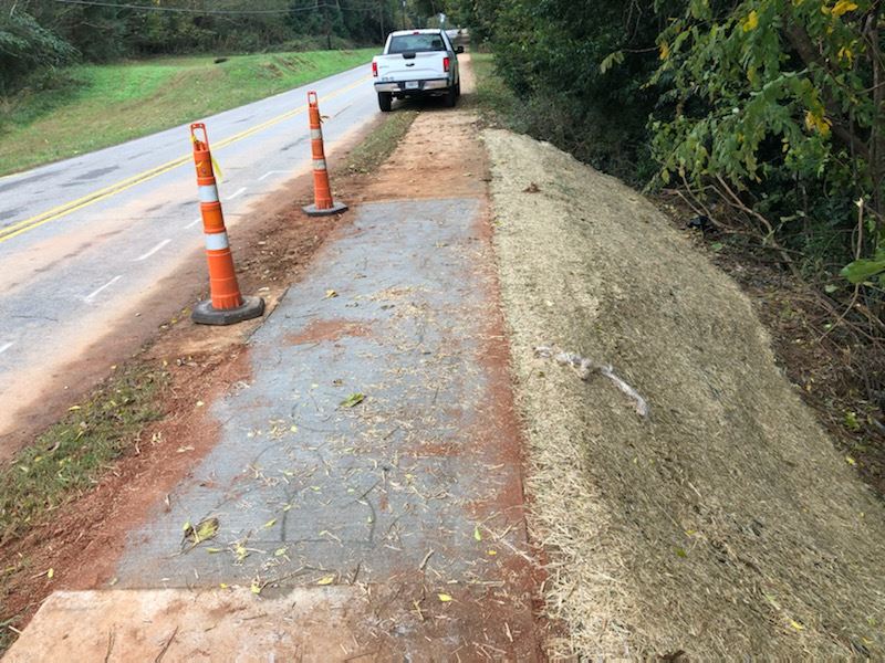 Two orange cones next to a slope