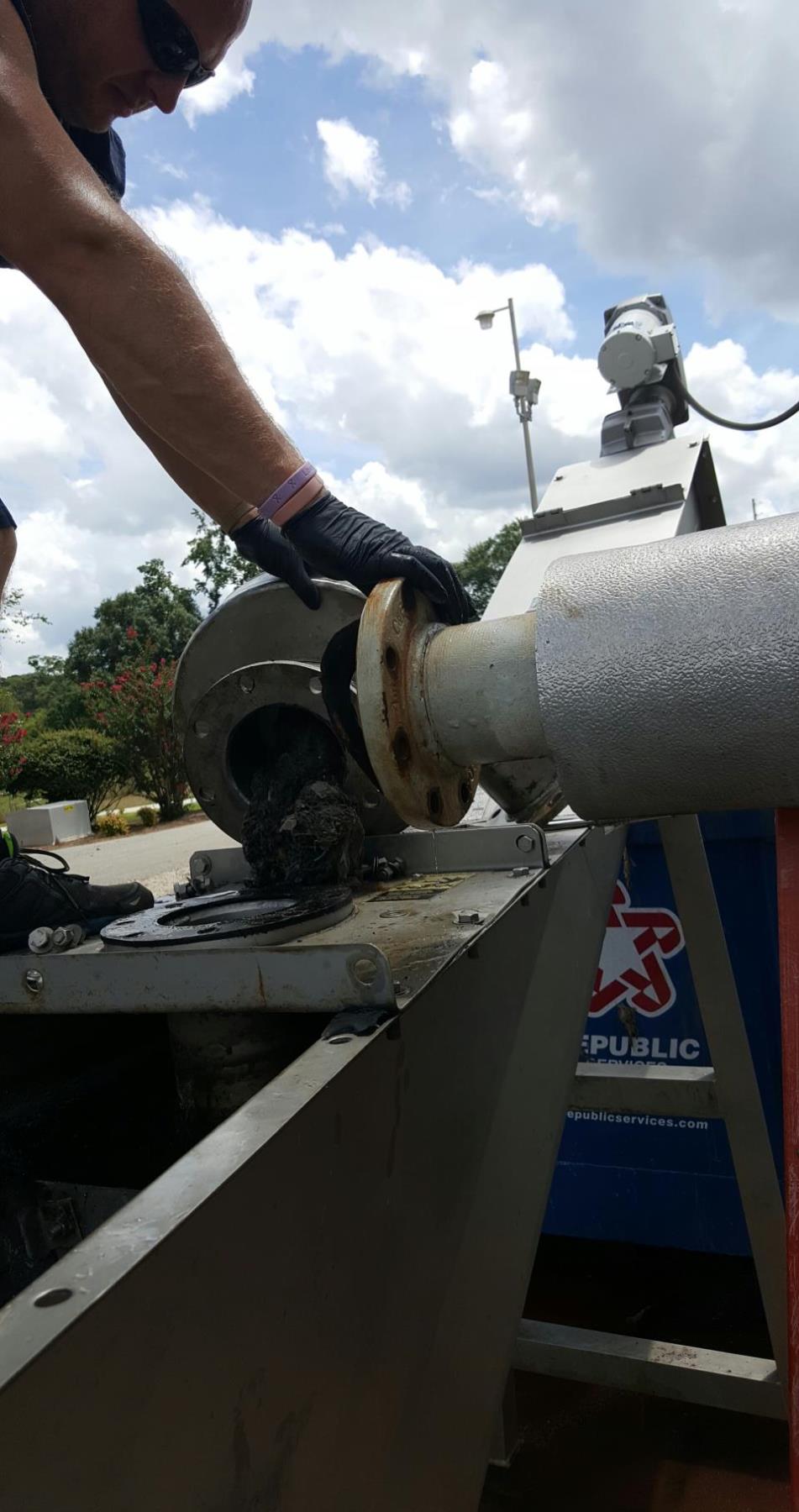 Person standing at a water treatment pipe