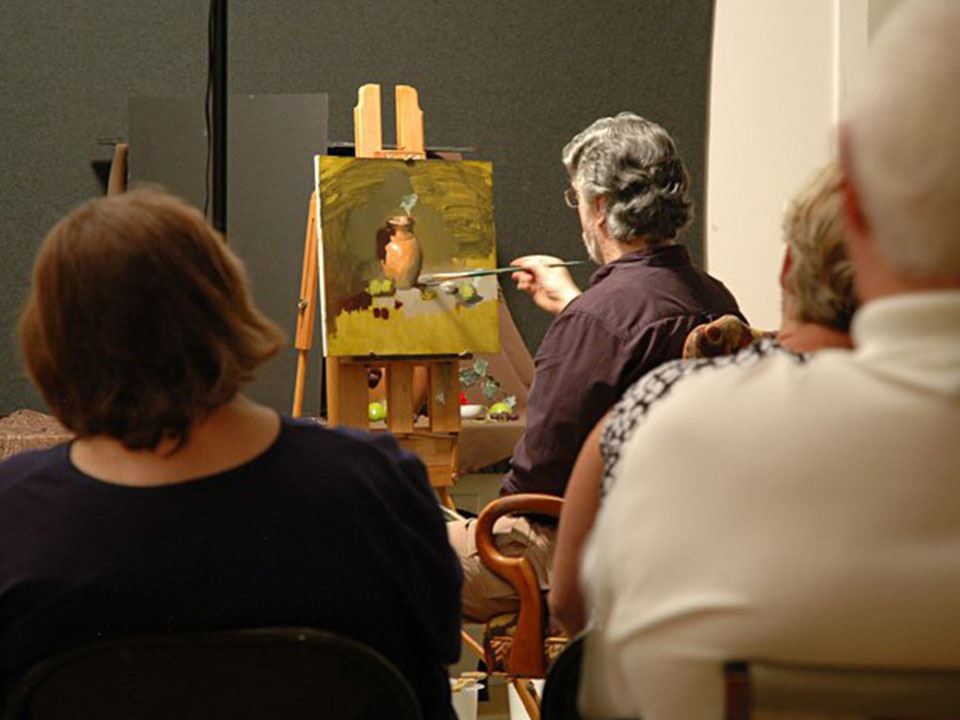 Person painting in front of others
