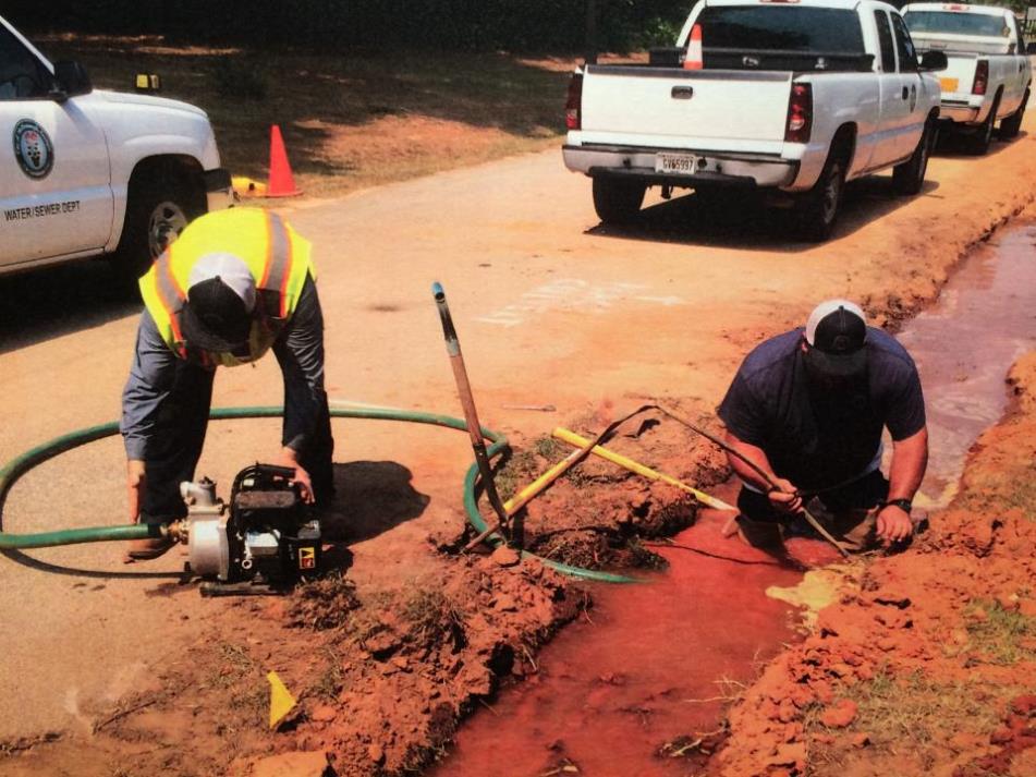 Workers maintaining a ditch